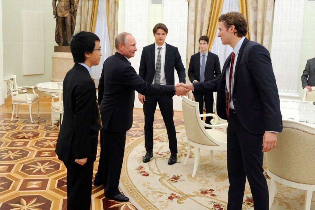 Etonian Trenton Bricken (right) meets Russian President Vladimir Putin in the Kremlin, as pupil David Wei (left), who organised the meeting, looks on. Photo: Facebook / Trenton Bricken
