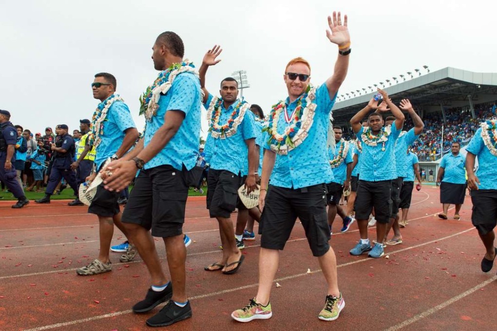 Fiji's rugby sevens coach Ben Ryan waving to the crowd during a victory ceremony. Photo: AFP