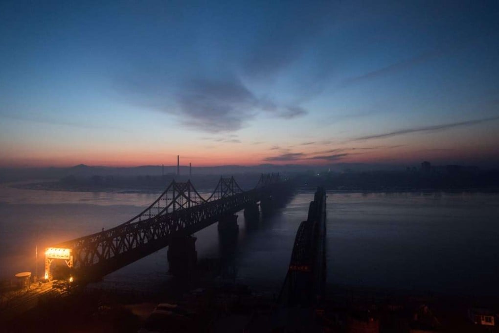 The sun rises over the bridge that connects the Chinese border town of Dandong with the North Korean town of Sinuiju. Krys Lee’s novel looks at the experiences of those who flee North Korea. Photo: AFP