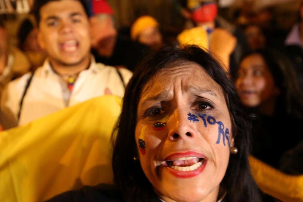 Venezuelans living in Peru take part in a protest outside the Venezuela embassy in Lima, Peru, to demand for a referendum to remove Venezuela's President Nicolas Maduro on Thursday. Photo: Reuters