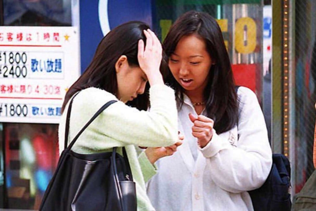 Two teenage girls, one in plain clothes and the other in a high school uniform cut high above the knee, stand at a corner of Ikebukuro town, Tokyo's entertainment and red-light district. Photo: AFP