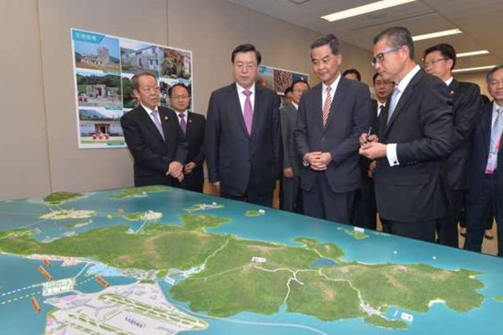 Paul Chan (front right with Chief Executive Leung Chun-ying) briefs top mainland officials on Lantau’s development. Photo: SCMP Pictures