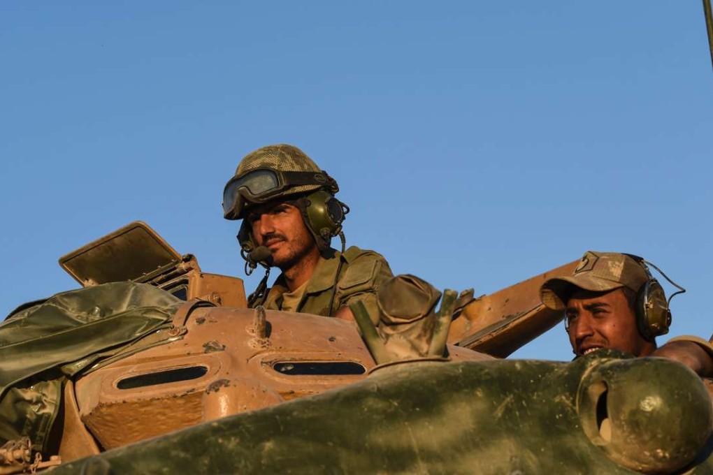 Turkish soldiers stand in a Turkish army tank driving back to Turkey from the Syrian-Turkish border town of Jarabulus on September 2. Photo: AFP