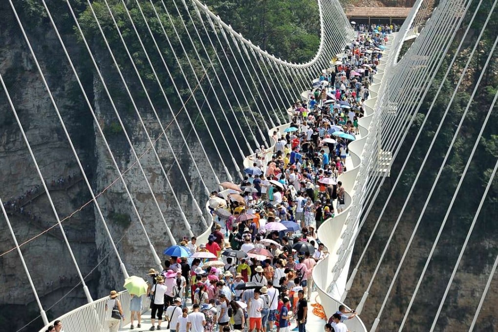 Large crowds of up to 10,000 people have visited the world’s longest glass bridge each day since it opened in Zhangjiajie, in Hunan Province. Photo: Reuters