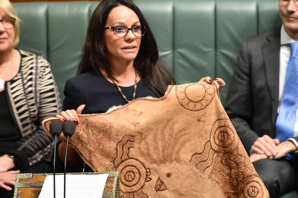 Linda Burney, holding up her cloak as she gives her first speech in the national parliament in Canberra. Photo: AFP