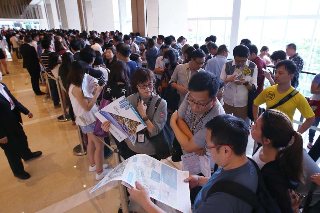 Potential buyers waiting outside sales office of China Overseas Land's One Kai Tak at Exchange Tower in Kowloon Bay. Photo: Felix Wong