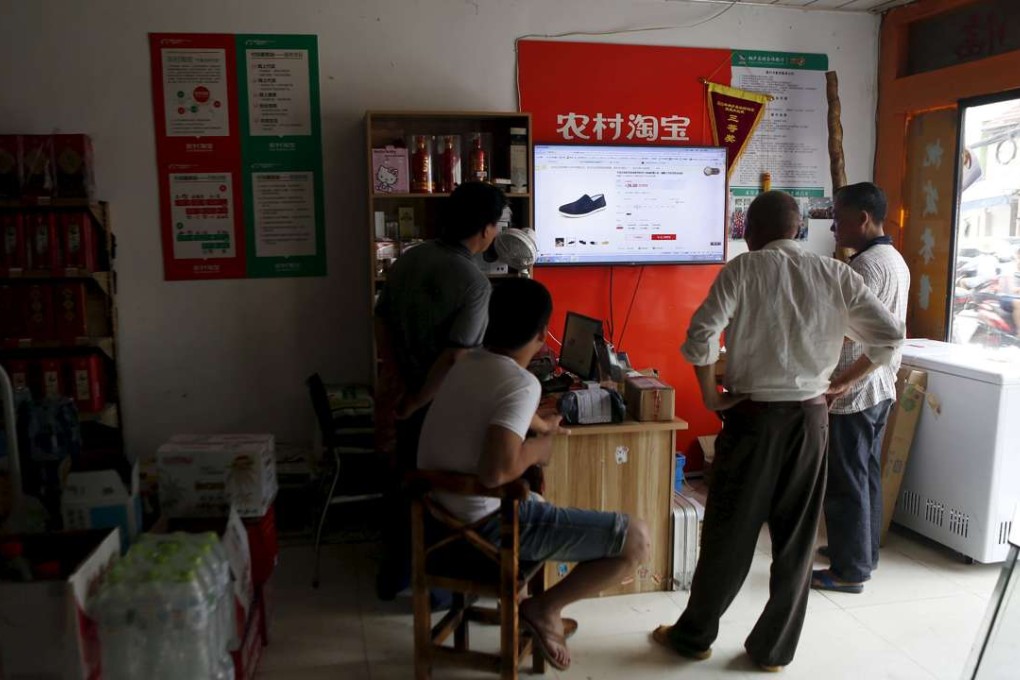 Villagers look at a screen displaying a website of Alibaba's Taobao at a rural service centre in Tonglu, Zhejiang province, China. A new platform called eWTP is being proposed to help small businesses trade on a global scale. Photo: Reuters