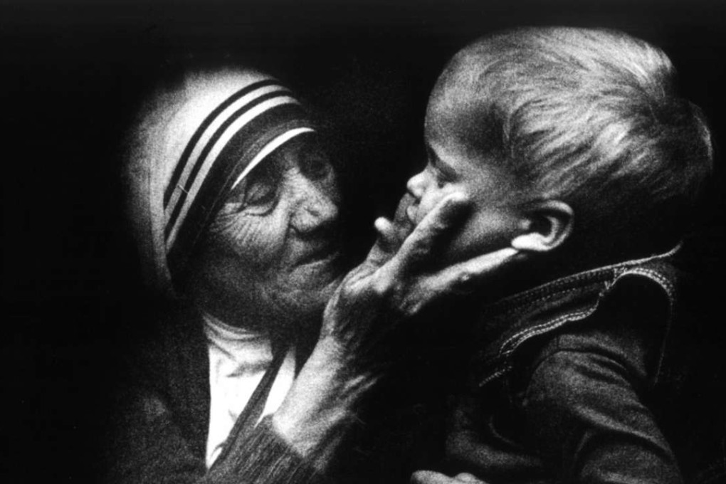 Mother Teresa from Calcutta, holds a Polish child during a visit to Poland. Photo: EPA