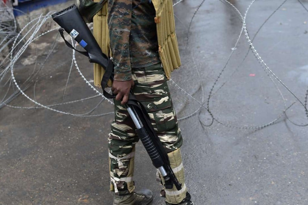 Indian paramilitary trooper holds a pump action shotgun. Photo: AFP