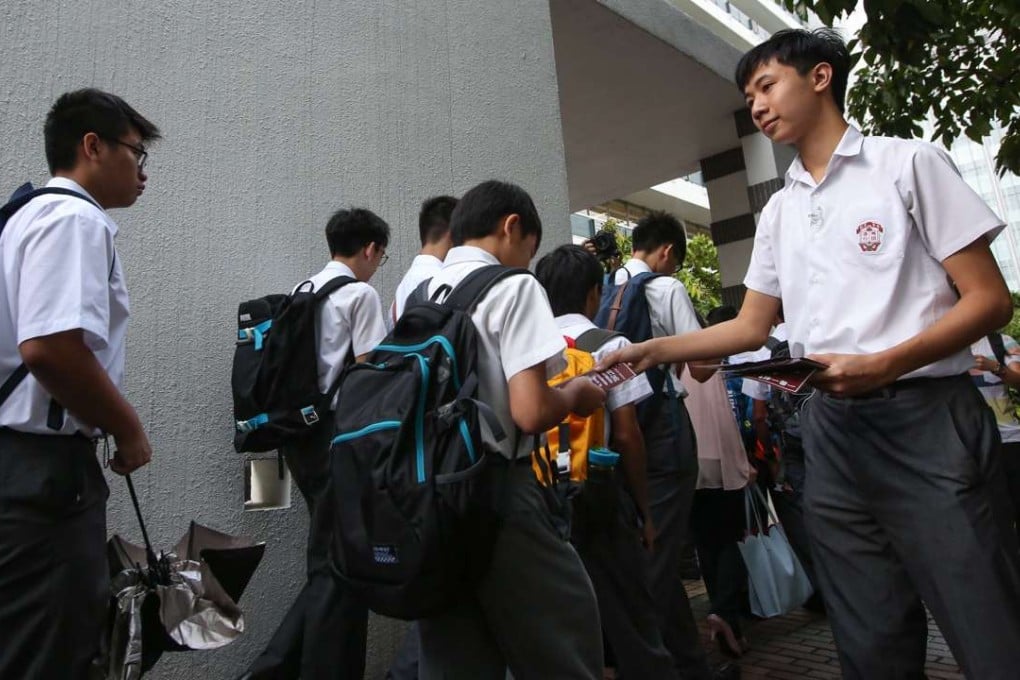 A student from Ying Wa College hands out leaflets on Hong Kong independence on the first day of school. Photo: Edward Wong