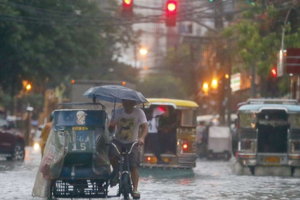 Filipino commuters and motorists wade or make their way as heavy monsoon rains inundate low-lying areas in Manila, Philippines. Typhoons that slam into land in the northwestern Pacific _ especially the biggest tropical cyclones of the bunch _ have gotten considerably stronger since the 1970s, a new study concludes. Photo: AP