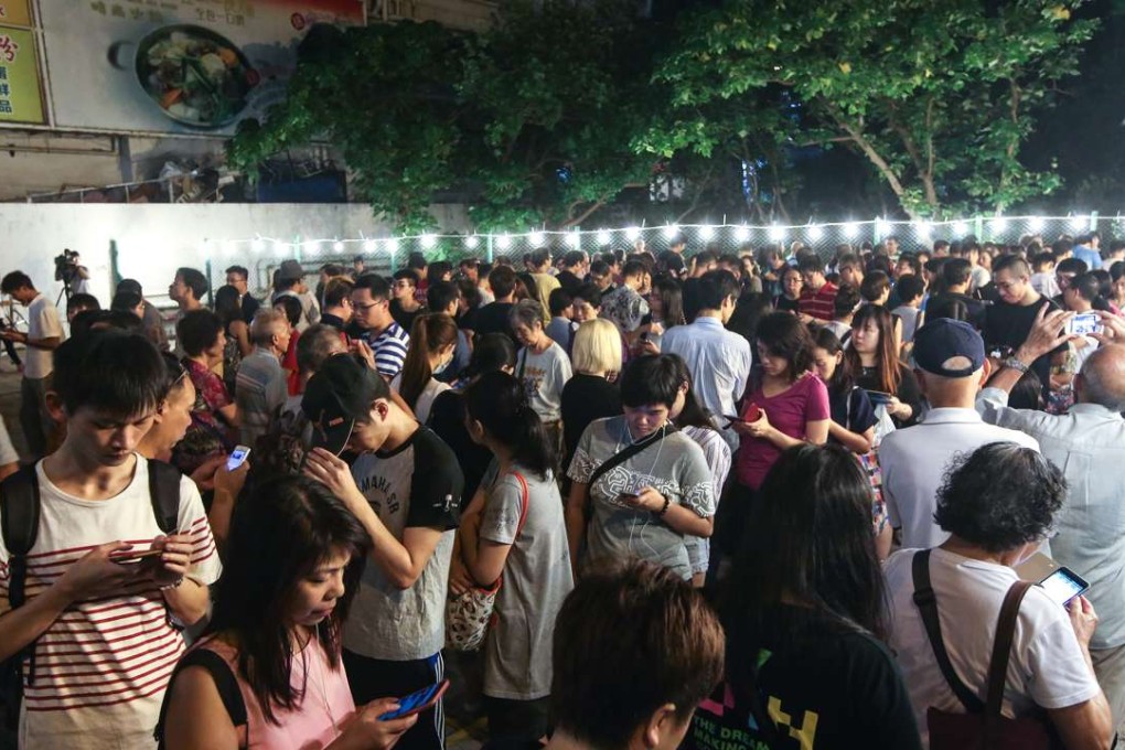 People queue up to vote for the Legislative Council election at a polling station in Lam Tin. Photo: Sam Tsang