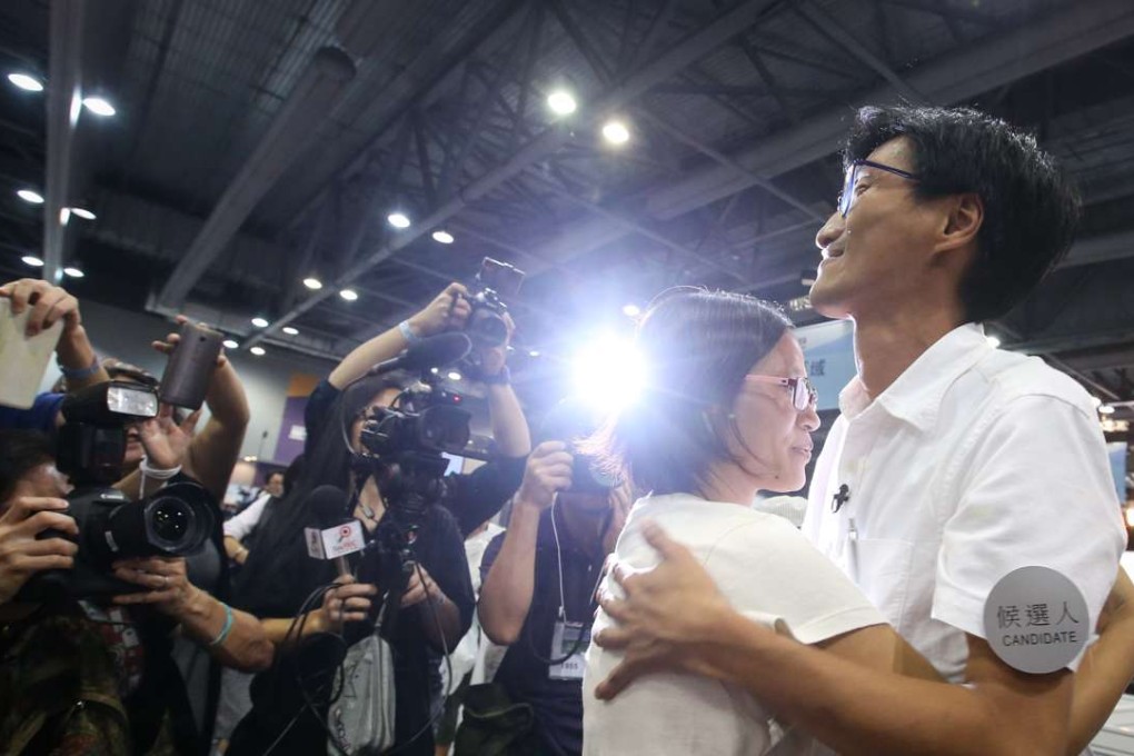Social and political activist Eddie Chu hugs his wife after becoming the ‘king of votes’, polling some 84,000. Photo: Felix Wong