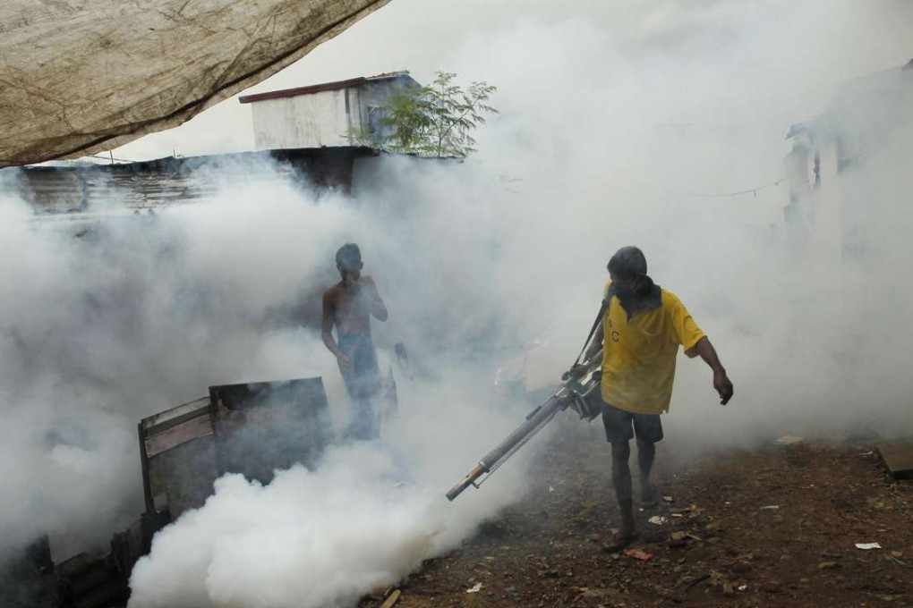 A Sri Lankan labourer fumigates buildings to control mosquitoes in Colombo, Sri Lanka. The World Health Organization has certified Sri Lanka as a malaria-free nation. Photo: AP