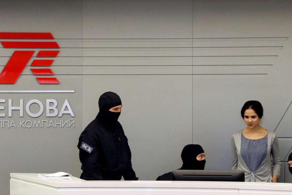 Members of Russia's security services are seen on Monday during a search of the offices of the Renova firm that it shares with subsidiary T Plus in Moscow. Photo: Reuters