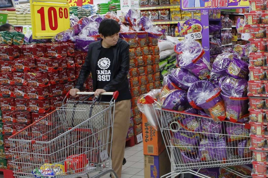 Tingyi's instant noodles are packed with a plastic bucket giveway at a supermarket in Beijing on October 9, 2013. Photo: Reuters