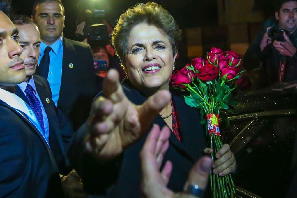 Former Brazilian President Dilma Rousseff greets supporters on her arrival at the Canoas air force base on Tuesday after leaving Alvorada Palace - the government palace - in Brasilia. Photo: AFP