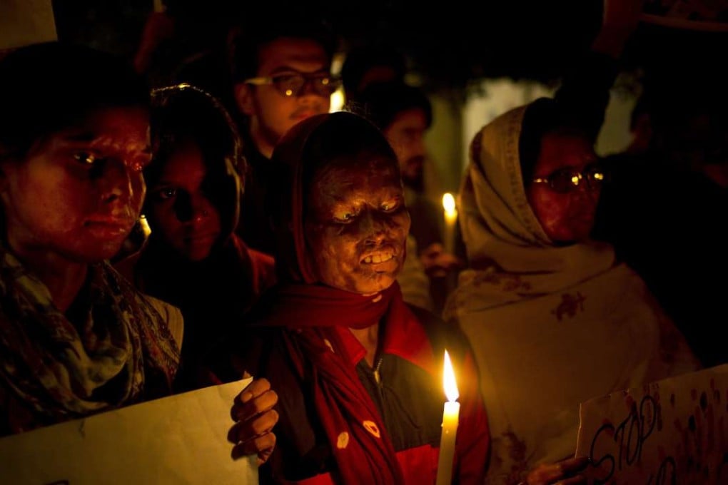 Acid attack survivors participate in a candlelit vigil protesting violence against women in New Delhi in 2014. Photo: AP