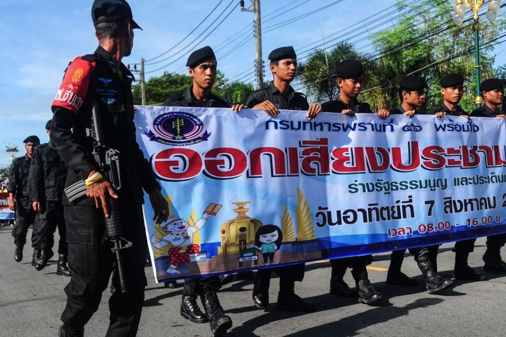 Thai soldiers march as part of a campaign encouraging the public to vote in the referendum on Thailand's draft constitution. Photo: AFP