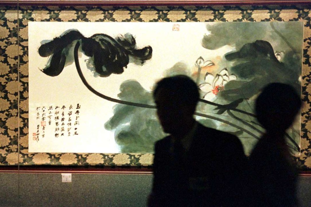 Museum-goers examine a painting at the National Palace Museum in Taipei, Taiwan. Photo: Reuters