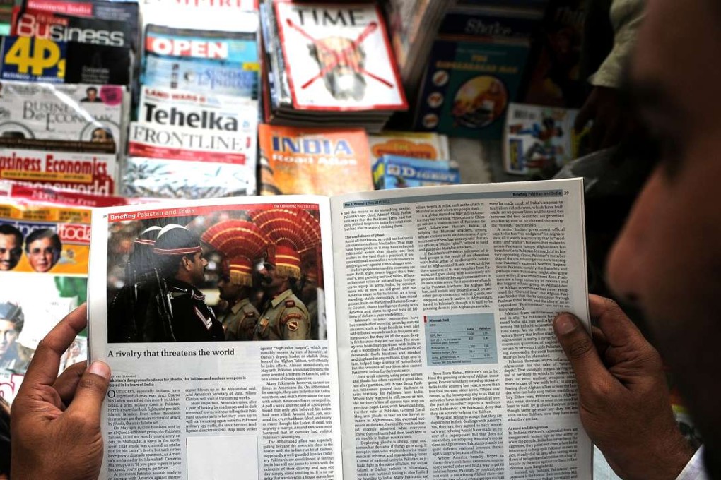 An Indian reads a censored magazine at a road-side stall in New Delhi. Photo: AFP