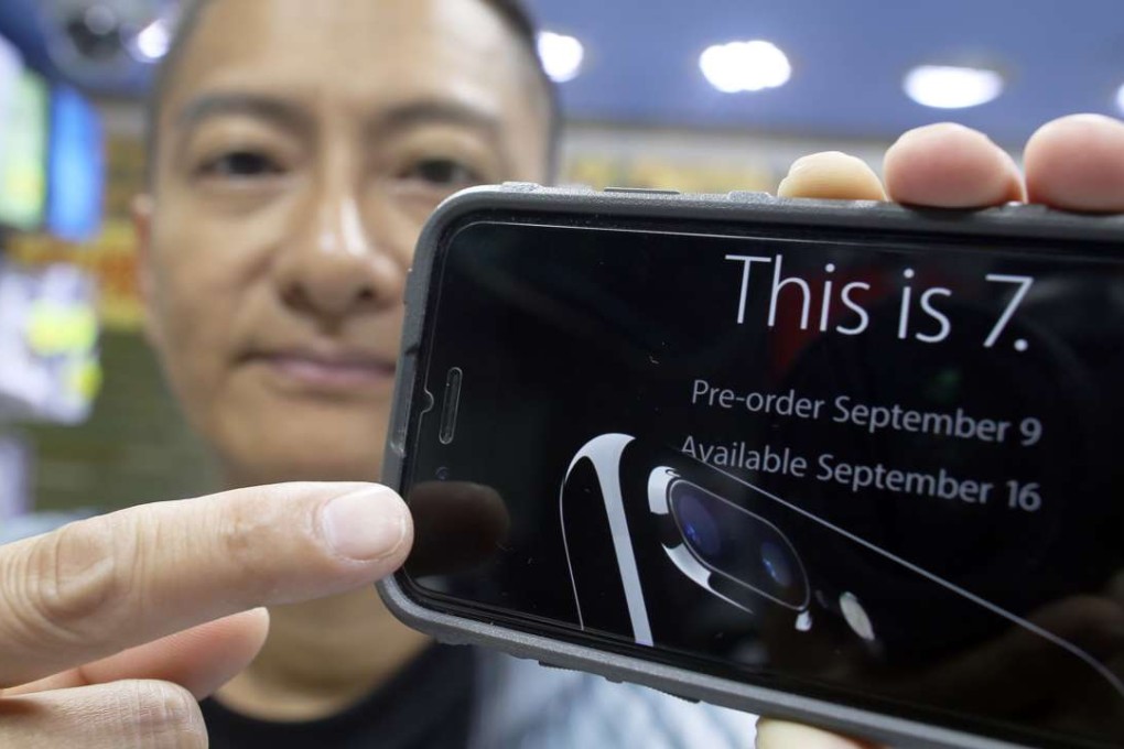 Lau Chi-kwong, a shop owner, shows an advertisement for the Apple iPhone 7 at Sin Tat Plaza in Mong Kok. Photo: Dickson Lee