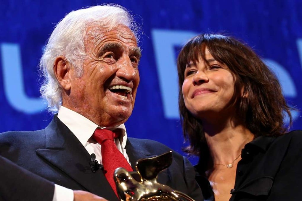 Actor Jean-Paul Belmondo smiles as he receives a Golden Lion award for lifetime achievement presented by French actress Sophie Marceau at the 73rd Venice Film Festival. Photo: Reuters