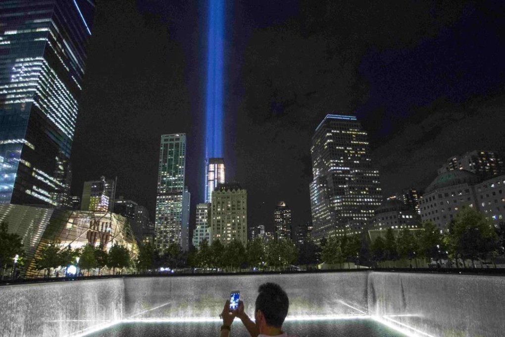 A man takes a photo at the 9/11 Memorial and Museum near the Tribute in Light in Lower Manhattan, New York. Photo: Reuters