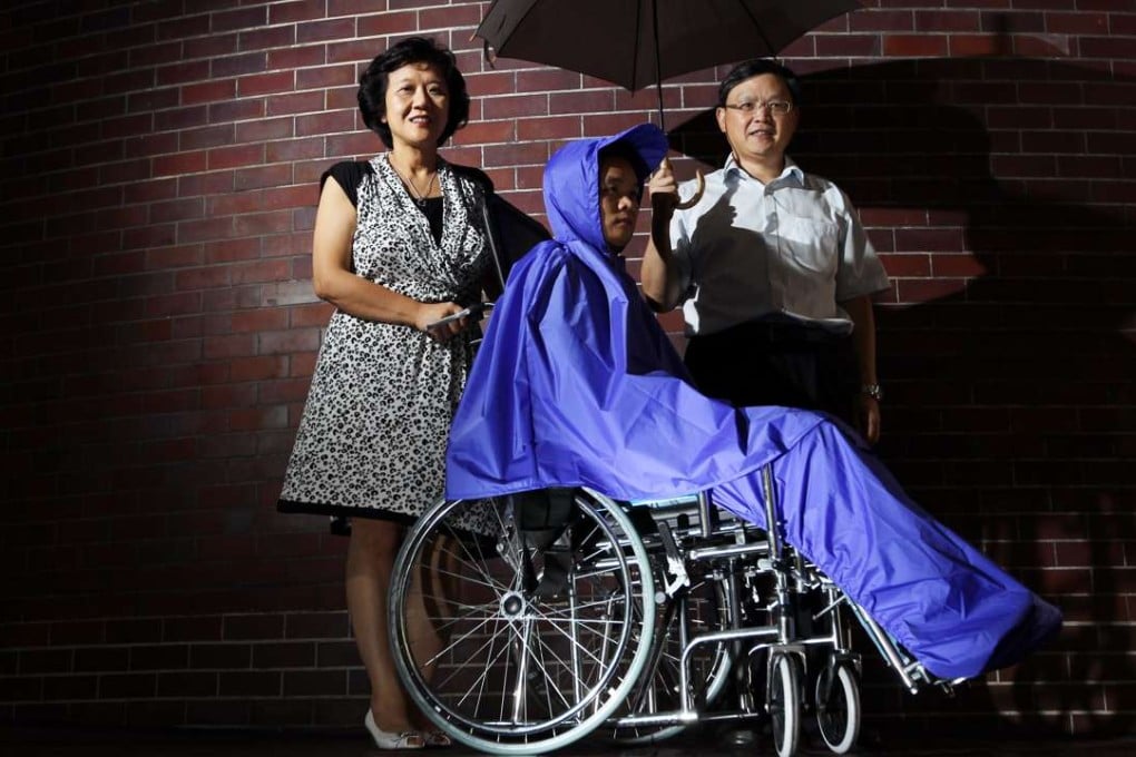 Dr Frency Ng, centre director of Troels H. Povlsen Care Apparel Centre at Hong Kong Polytechnic (left) and Dr Patrick Hui Chi-leung, associate professor of the Institute of Textiles and Clothing, with the raincoat designed for the wheelchair-bound. Photo: Nora Tam
