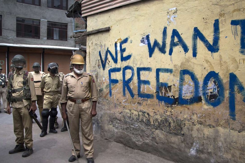 Indian policemen stand guard during a curfew in Srinagar, Indian-controlled Kashmir. Photo: AP