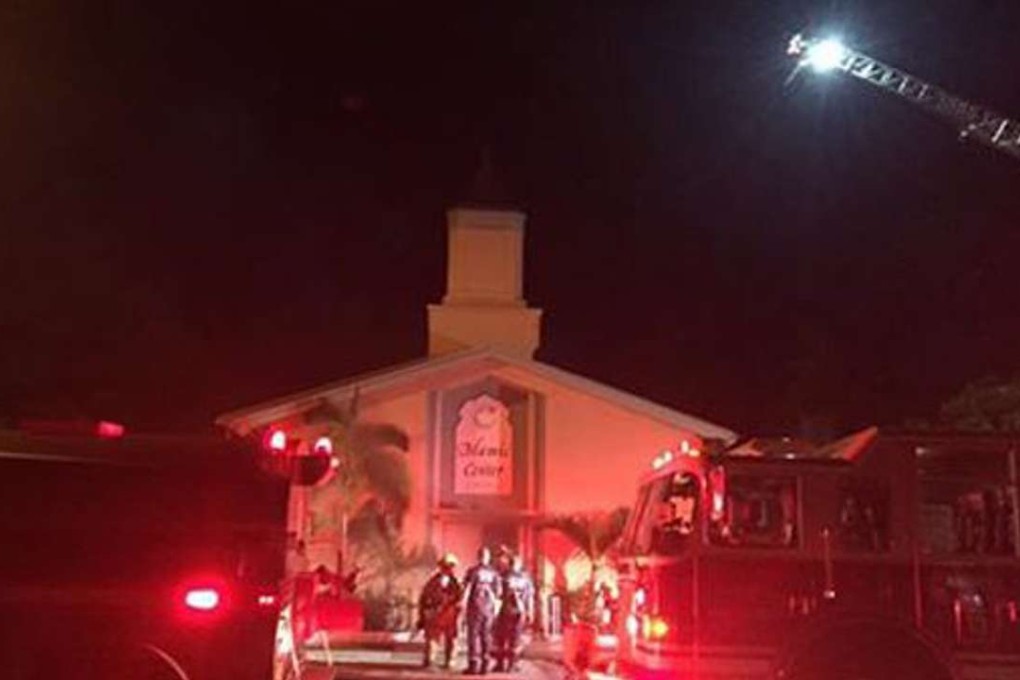 A handout photo provided by the St Lucie County Sheriff's Office on Monday shows firefighters and police responding to a fire at the Islamic Centre in Fort Pierce, Florida. Photo: EPA
