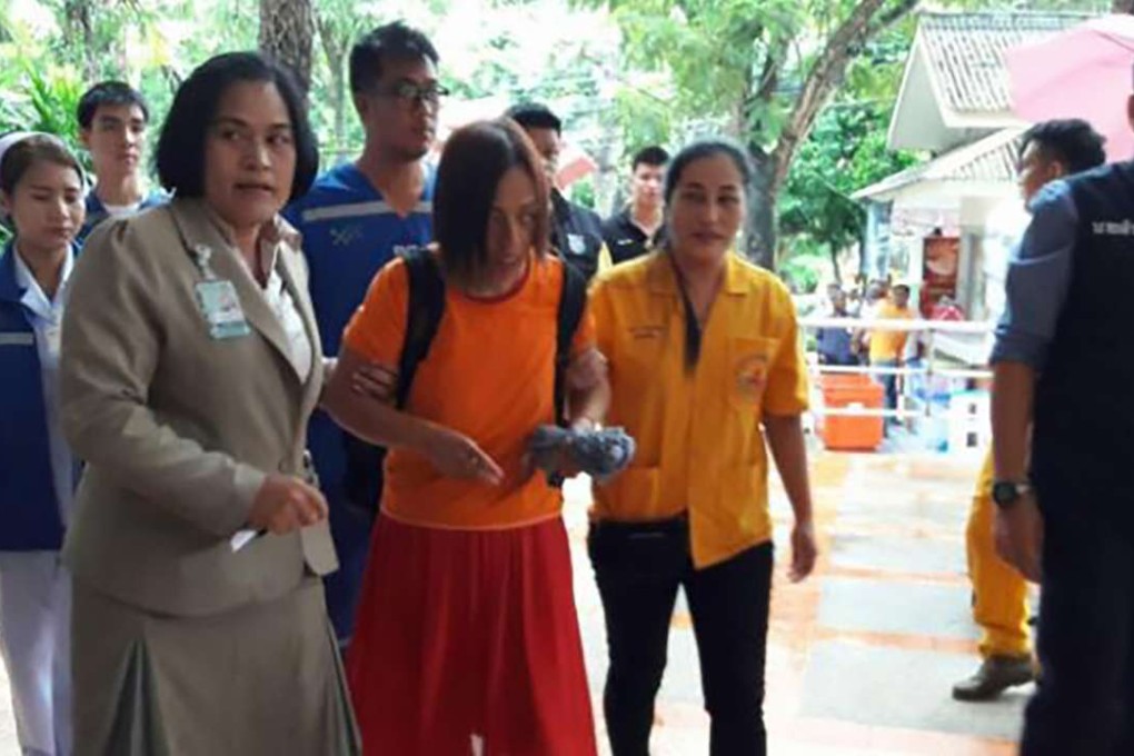 Gao Liping, centre, is escorted to hospital after going missing for two days from a tiger zoo park in Pattaya, Thailand. Photo: SCMP Pictures