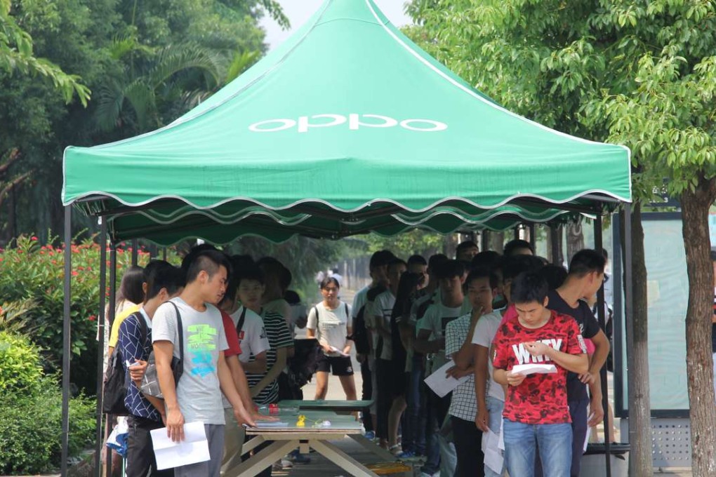 Young job seekers line up in hopes of work outside Oppo Factory in Dongguan. Photo: Sidney Leng