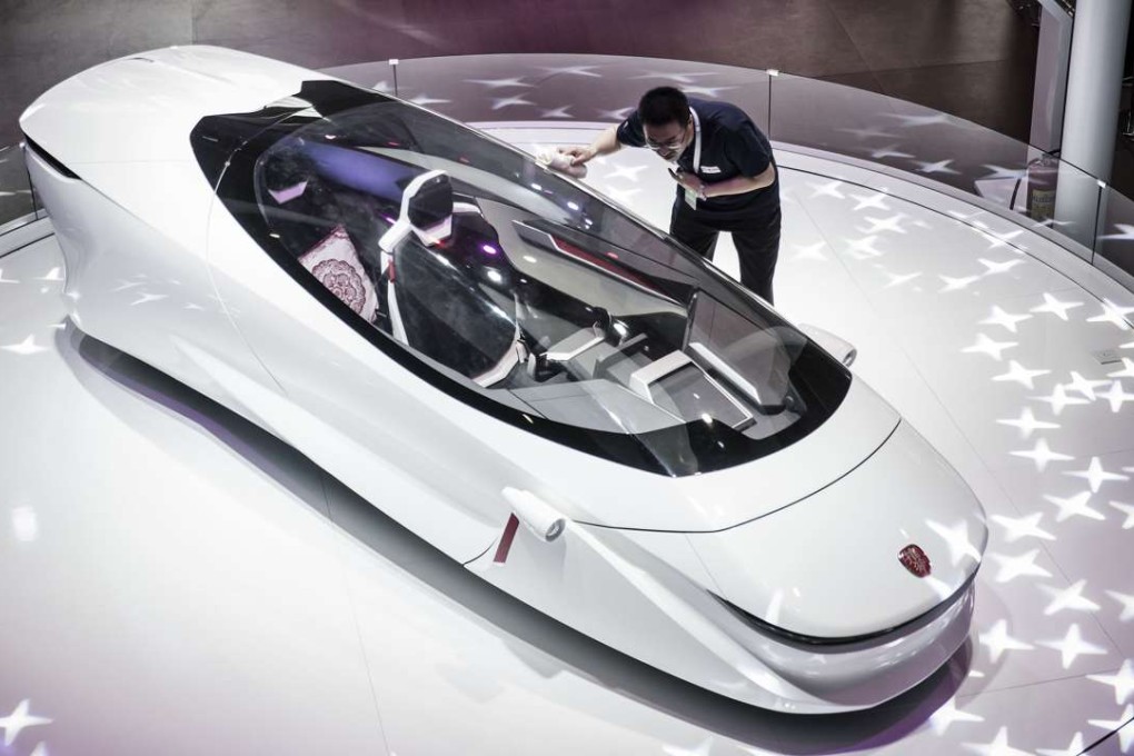 An employee cleans the windshield of a Beijing Lingyun Zhineng Technology Co concept electric two-wheel vehicle at the Beijing International Automotive Exhibition in Beijing in April. Photo: Bloomberg