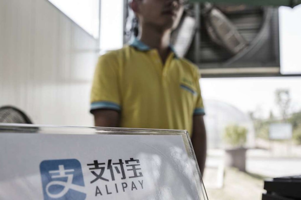 A sign for Alibaba Group Holdings Ltd.'s AliPay service is displayed at a Zhejiang Transfar Co. facility during a media tour in Hangzhou, China. Photo: Bloomberg
