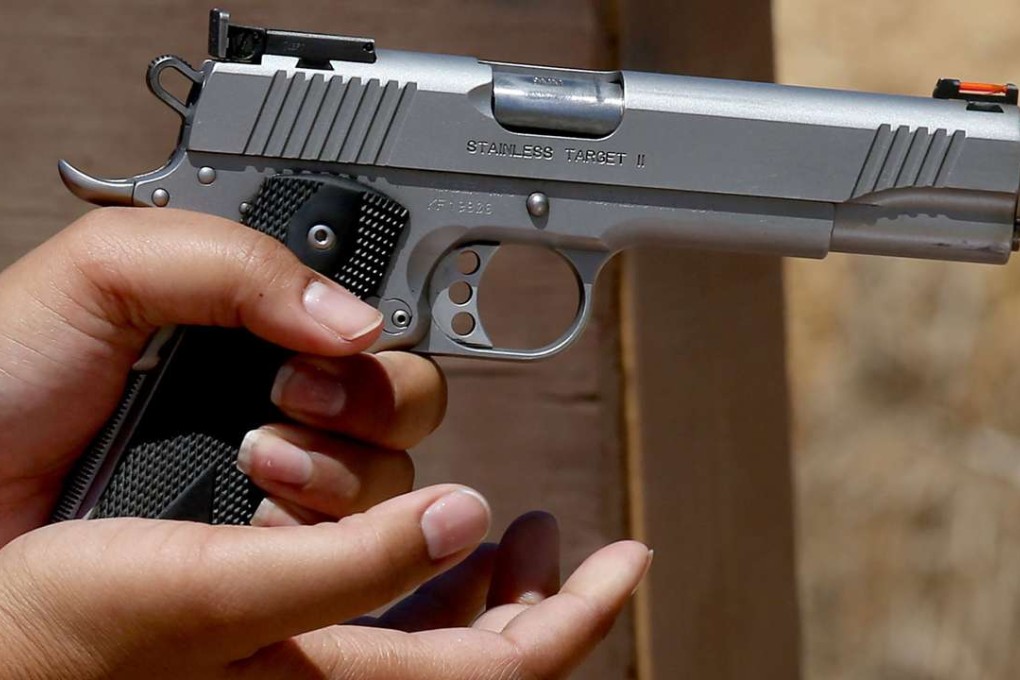 In an August 14 file photo, a gun owner loads her pistol at a gun range in Piru, California. Photo: TNS