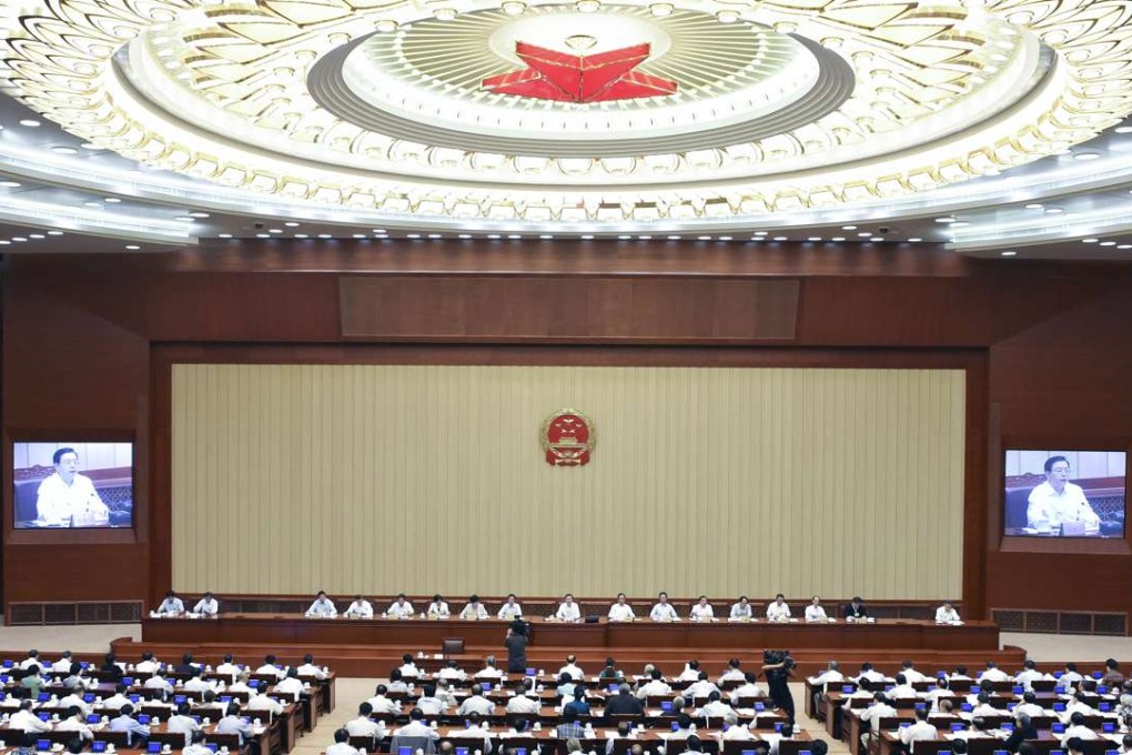 Zhang Dejiang, chairman of the Standing Committee of the National People's Congress (NPC), presides over a committee meeting in Beijing on Tuesday. Photo: Xinhua