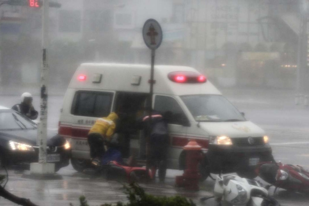 Rescuers carry a victim as high winds and rain lash Kaohsiung in southern Taiwan on Wednesday. Photo: EPA