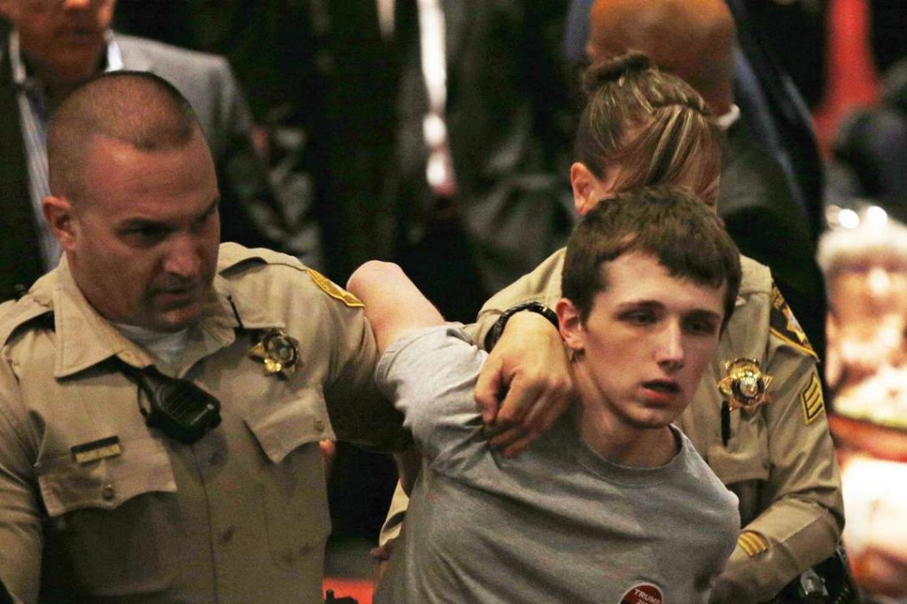 In this June 18, 2016, photo, police remove Michael Sandford from a rally attended by Donald Trump at the Treasure Island hotel and casino in Las Vegas. Photo: AP