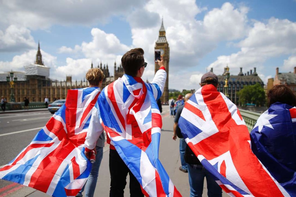People walk over Westminster Bridge wrapped in Union flags following Britain’s Brexit vote. Photo: AFP