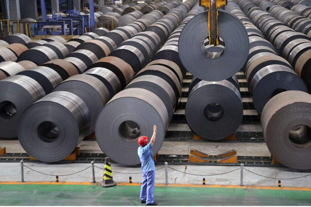 A roll of steel sheet is guided into position at a factory in Handan, Hebei province. Moody’s notes that some provinces heavily exposed to excess-capacity industries such as coal, steel and basic manufacturing are lagging behind the national average. Photo: Reuters
