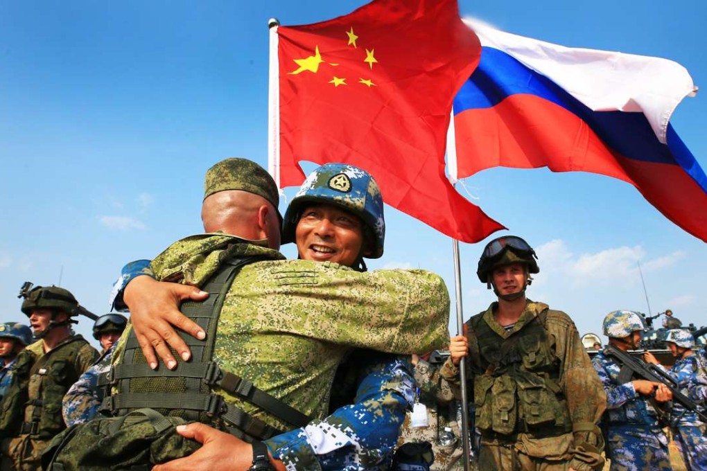 A Chinese and Russian marine hug one another during their nations’ joint naval drills in Zhanjiang, Guangdong province on Wednesday. Photo: Xinhua