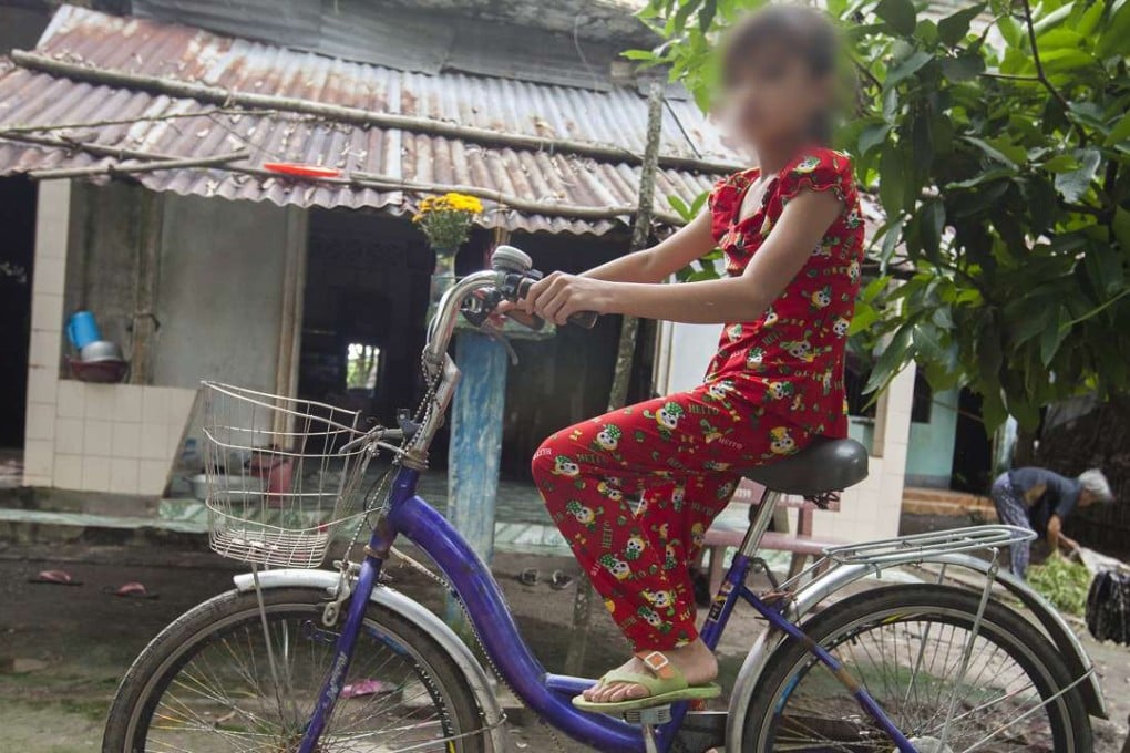 Truc Ly outside the home she shares with her grandmother, in An Giang province, in Vietnam’s Mekong Delta. Pictures: Red Door News Hong Kong