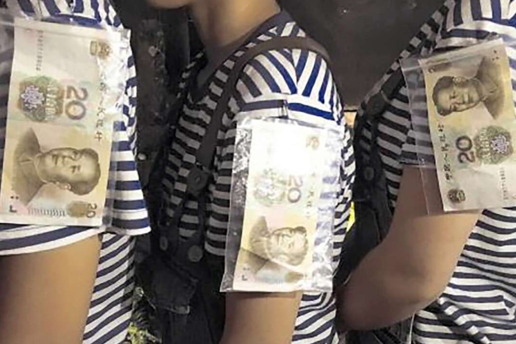 Waitresses at the Go To My House restaurant in Zhejiang province display 20-yuan banknotes pinned to their uniforms, which dissatisfied customers are able to claim when they leave. Photo SCMP Pictures