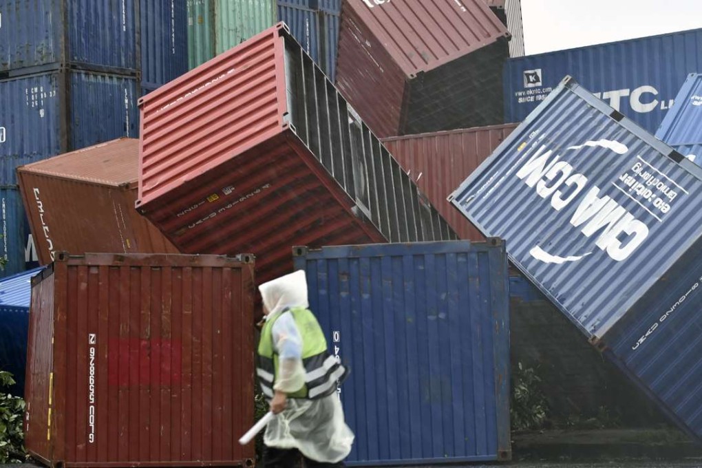 A man walks past downed shipping containers at the Kaohsiung Harbour as Meranti lashed southern Taiwan on Wednesday. Photo: AFP