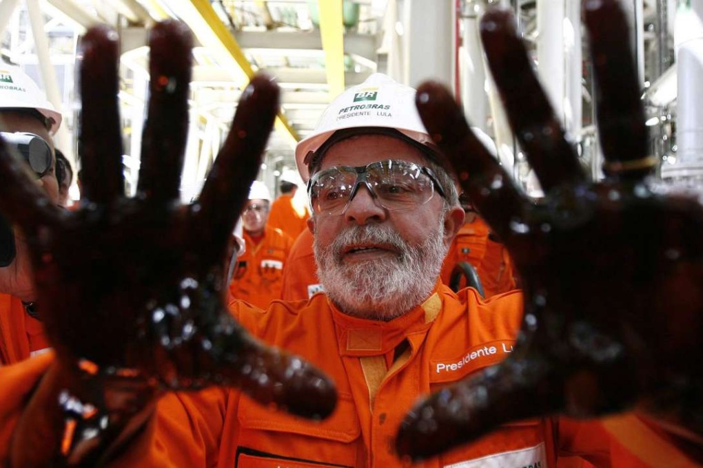 Brazilian former president Luiz Inacio Lula da Silva poses with his hands covered in oil in 2010 as he takes part in the launch of an oil platform owned by Petrobras, the state-run energy company now at the centre of a vast corruption scandal. Photo: EPA