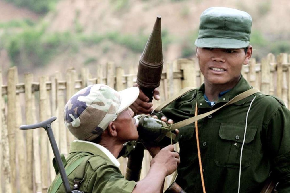 A Wa soldier drinks water from his comrade’s bottle. The United Wa State Army (UWSA) is Myanmar’s most powerful ethnic armed force – and is supplied by Chinese arms dealers. Photo: AP