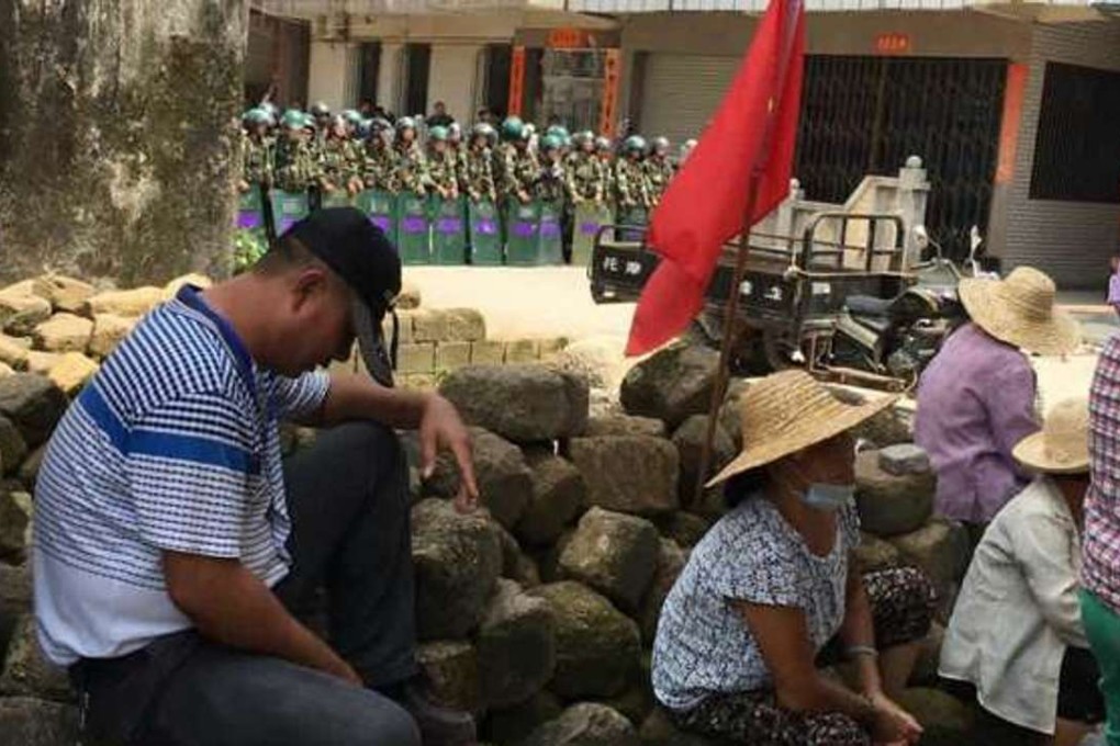 Villagers rest under the watch of security officers in Wukan in Guangdong province. Photo: SCMP Pictures