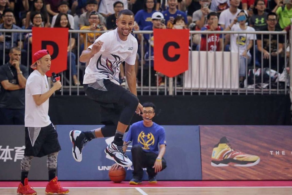 Stephen Curry (centre) wows the crowds, during the whistle-stop tour.