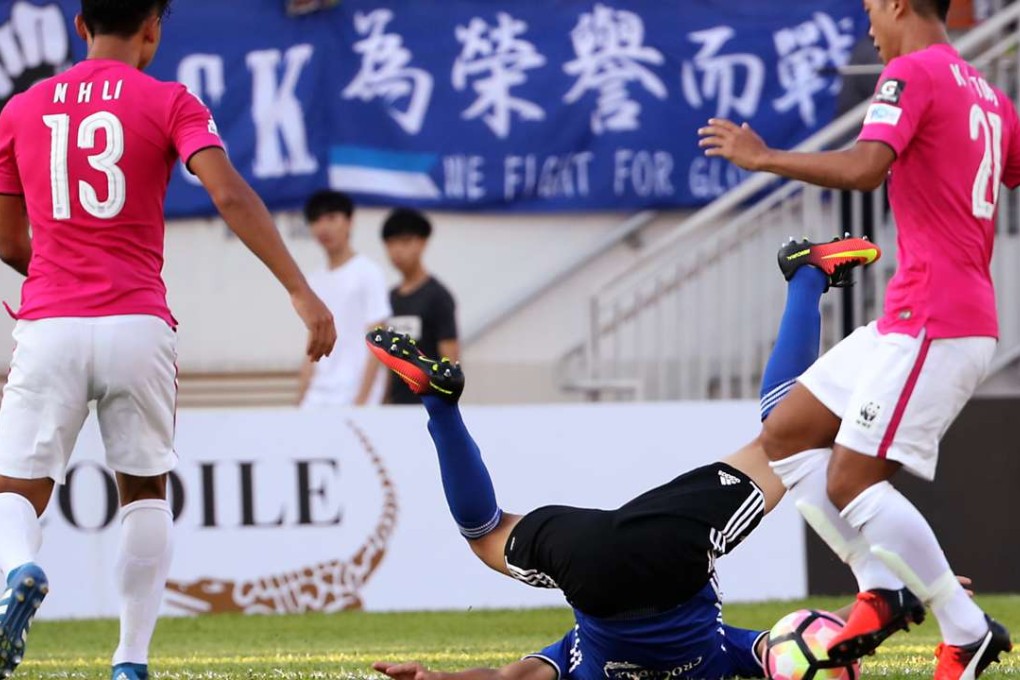 Eastern’s Xu Deshuai falls to the ground as he is surrounded by Kitchee's Li Ngai-hoi and Tong Kin-man during Friday’s HKJC Community Cup. Photos: Edward Wong